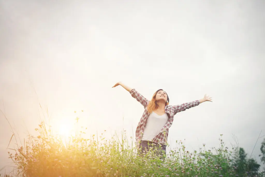 Womaian in sunny field happy
