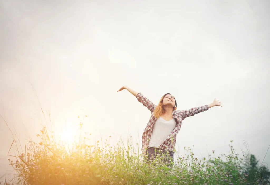 Womaian in sunny field happy