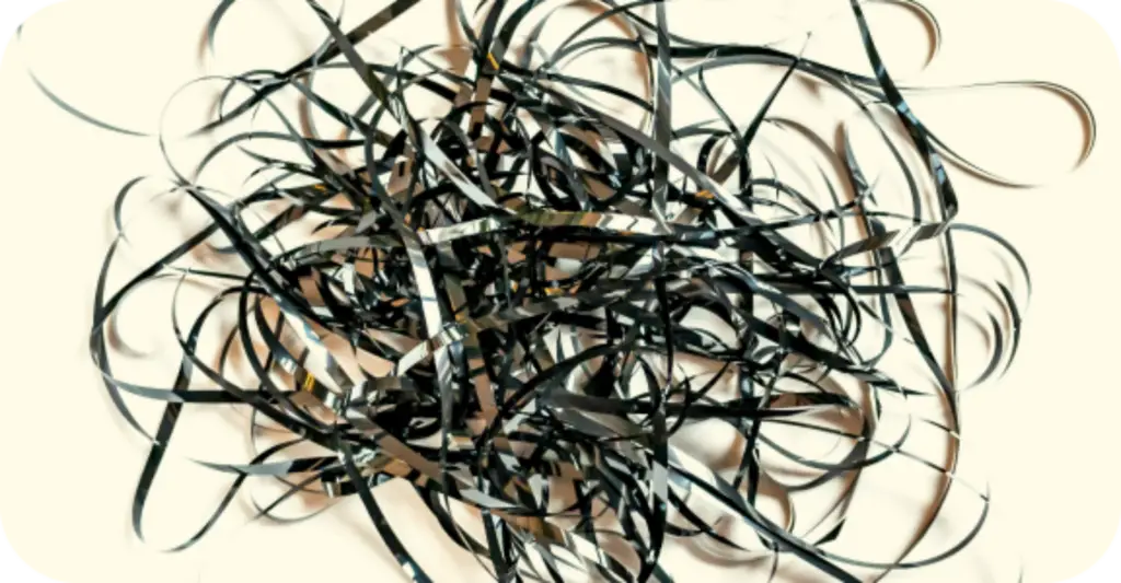 Tangled ribbon representing overwhelm and the challenge of finding clarity in personal growth.